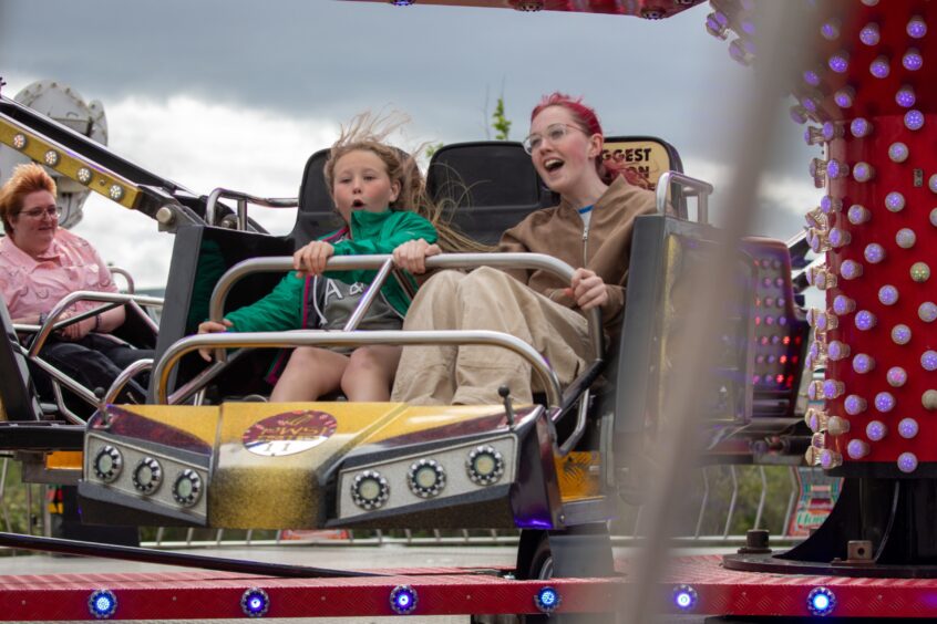 Two children on a funfair ride.