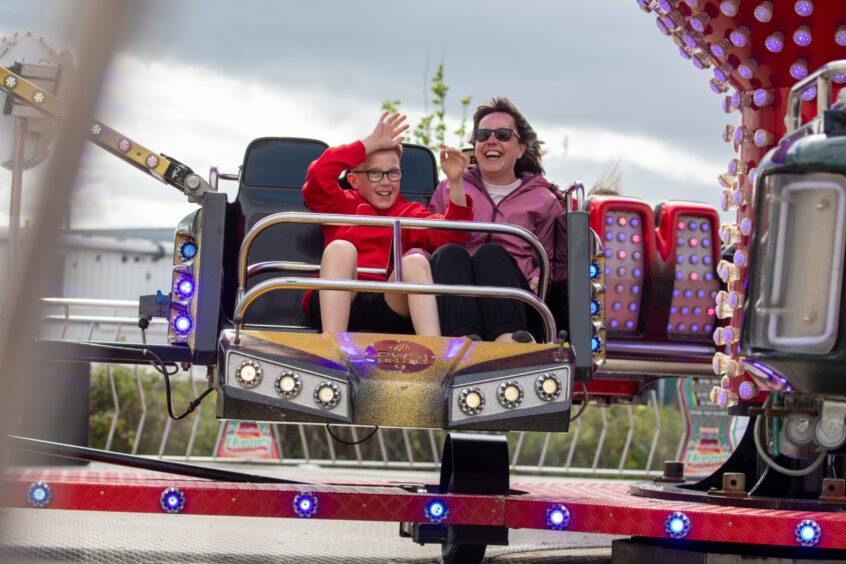A young boy and woman on a funfair ride