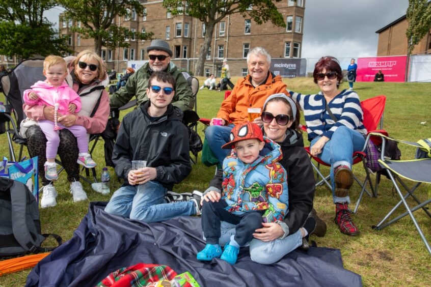 The Mann family sit together on the grass