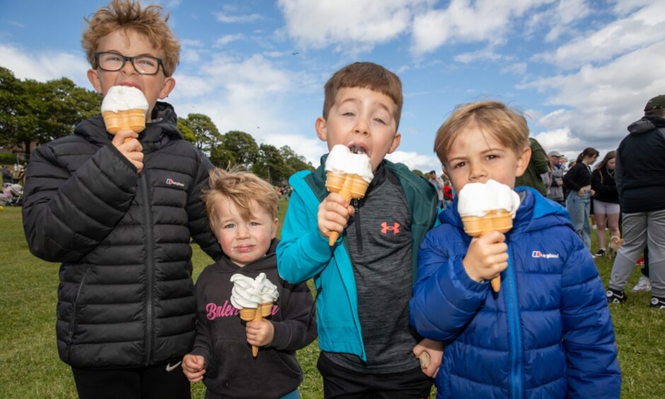 Four young boys eat ice creams at Westfest.