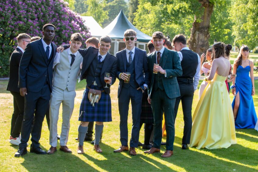 Boys in formal suits and kilts