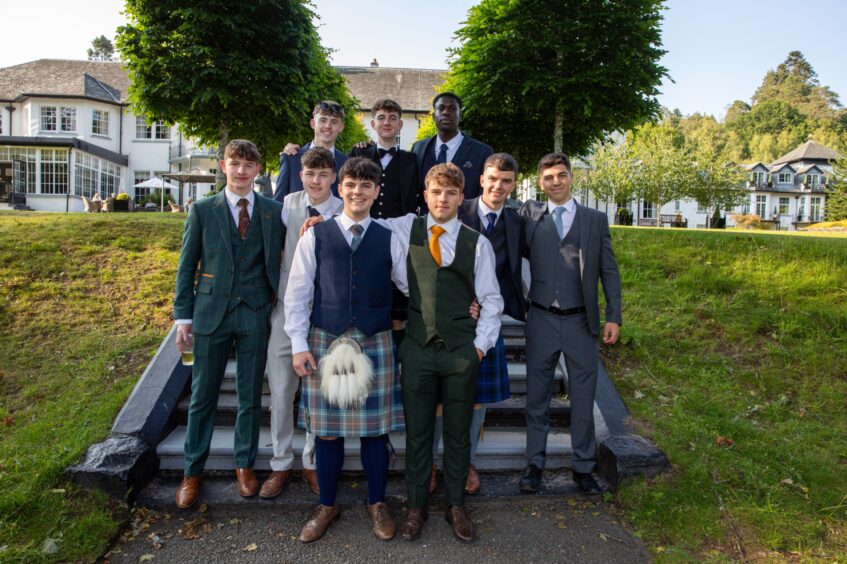 A group of boys pose at some stairs