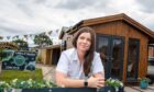Cara Mackay leaning on fence at Gillies and Mackay site