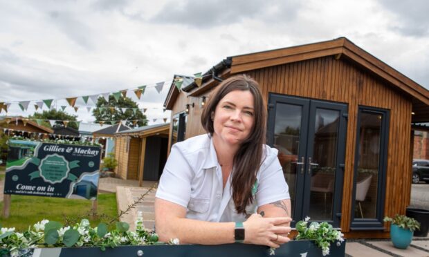 Cara Mackay leaning on fence at Gillies and Mackay site