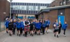 Piping pupil Robbie Melvin leads the farewell to Monifieth High. Image: Kenny Smith/DC Thomson