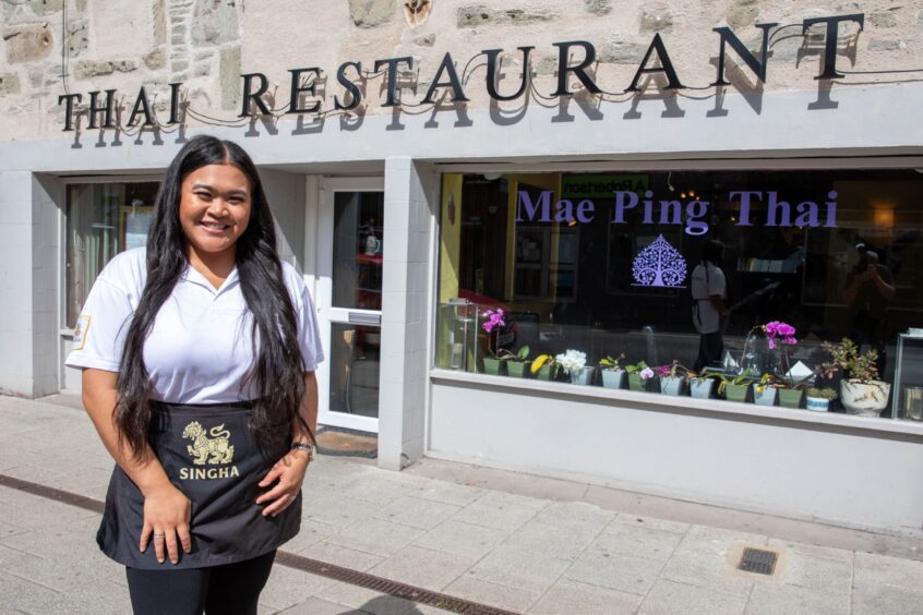 Nongmay standing in front of Mae Ping Thai restaurant