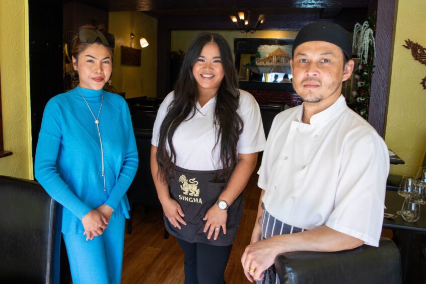 Nomgmay with father in chef gear and mother in elegant blue dress