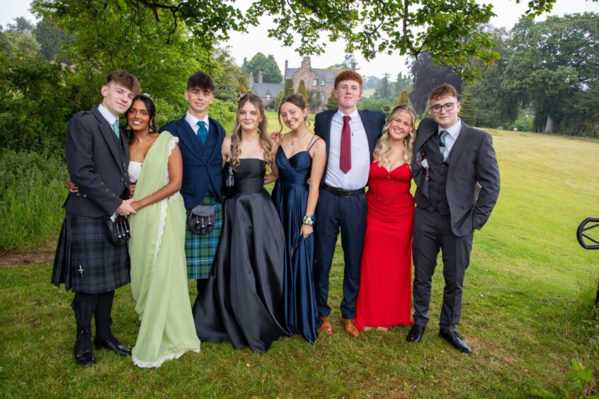 A group of pupils smile at Fingask Castle.