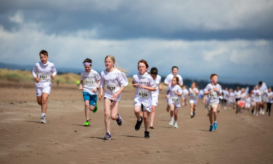 A small group of children lead the pack at the Chariots of Fire Beach Race