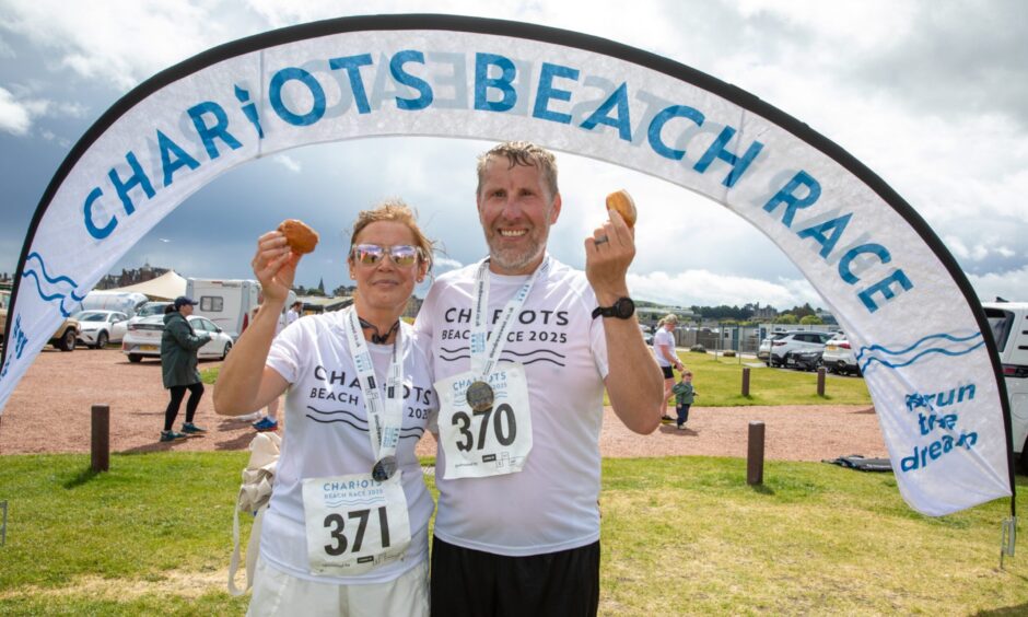Rachael and James Luff from Dunfermline with their medals and a fudge doughnut each
