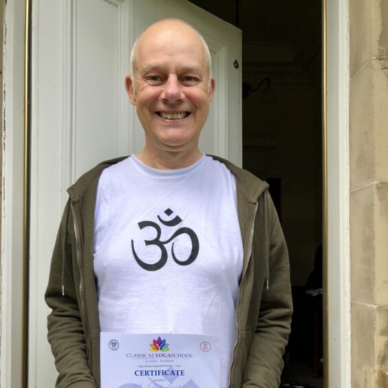 Les Ball with his yoga qualification.