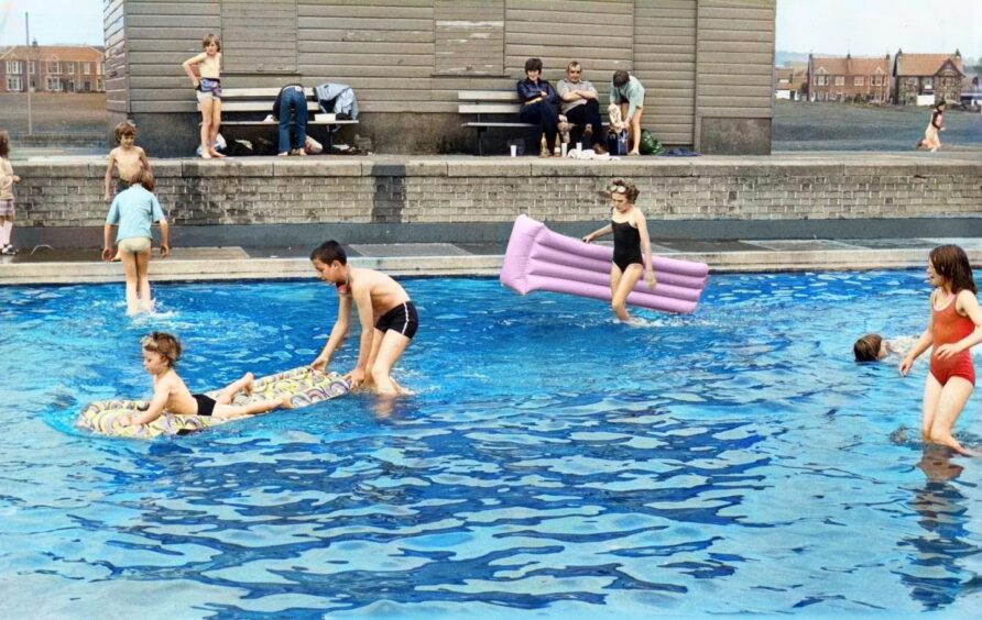 Youngsters having fun in the paddling pool at Leven in July 1980.