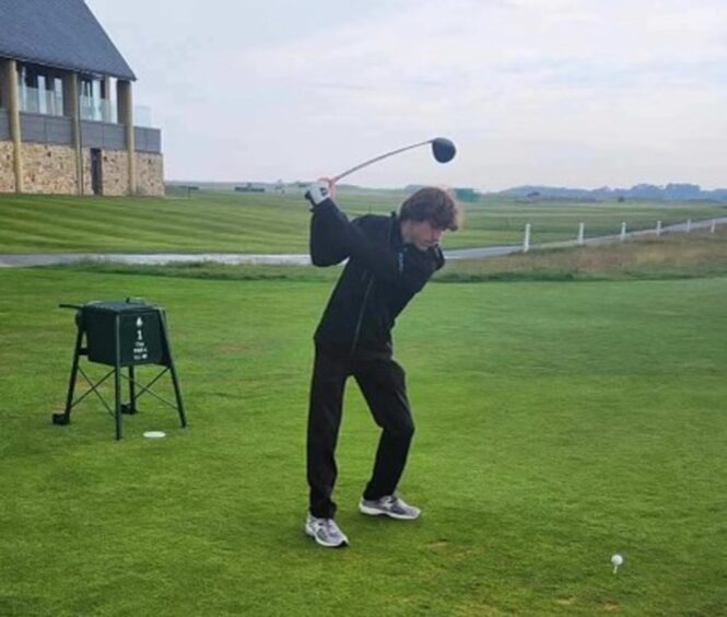 Matthew tees off.