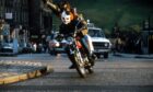 The Clown and The Wolfman on a motorbike in Edinburgh in a scene from Restless Natives