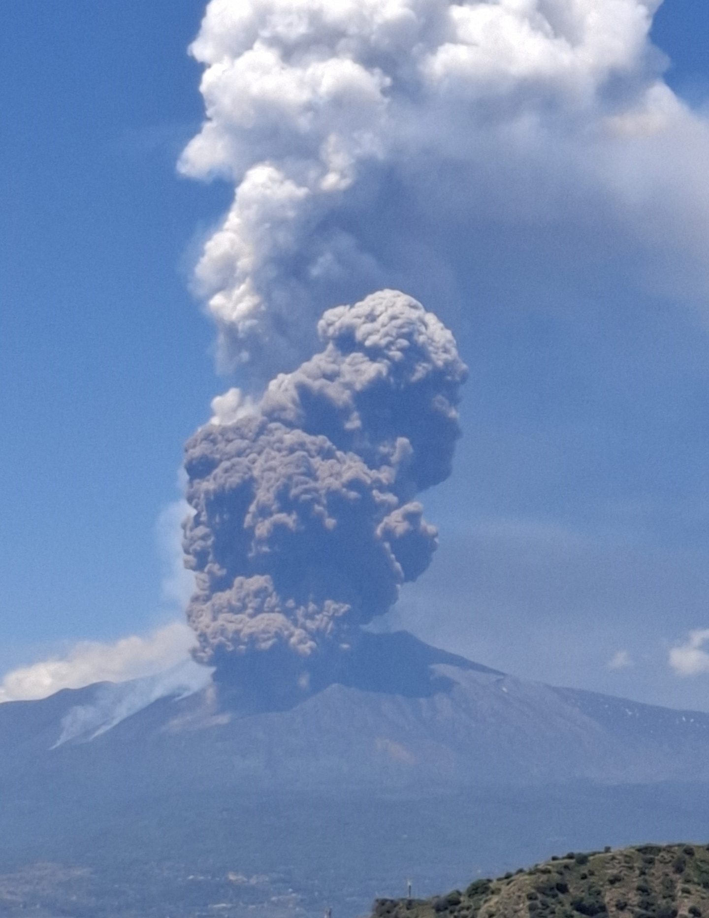Huge clouds of ash and smoke billow out of Mount Etna as it erupts.