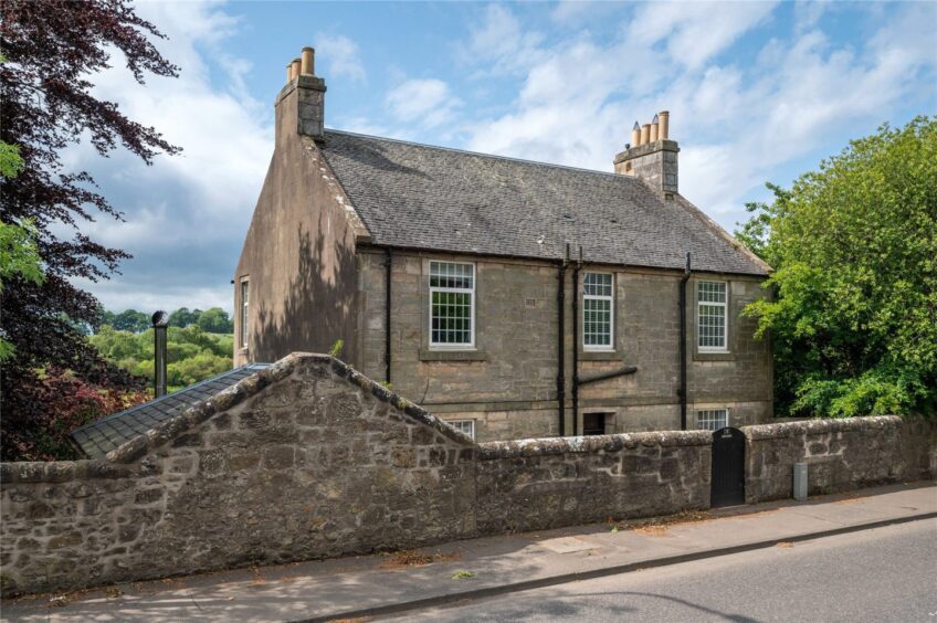 The Dunfermline home with stables from the road.