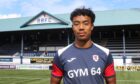 New Raith Rovers signing Richard Chin standing in front of the main stand at Stark's Park.