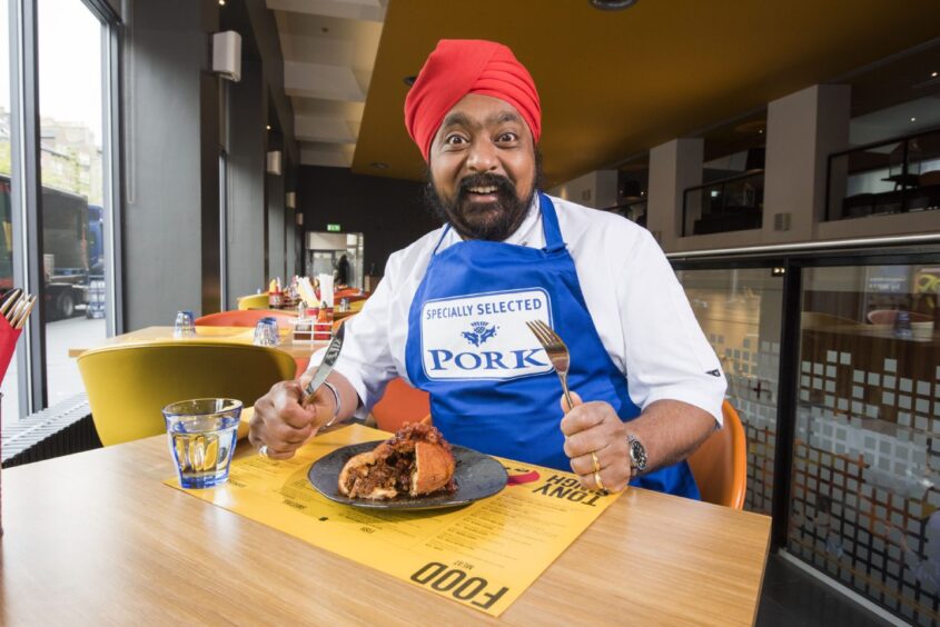 Chef Tony Singh sits at a table