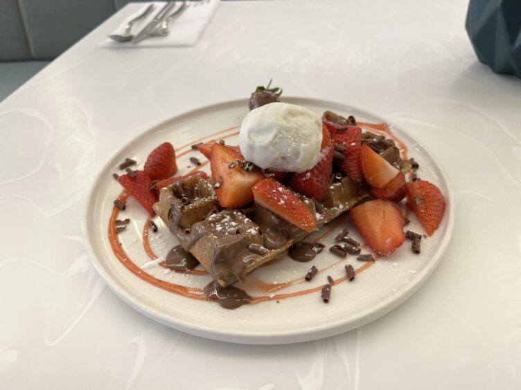 A dish of ice cream and waffles from HD Caffe