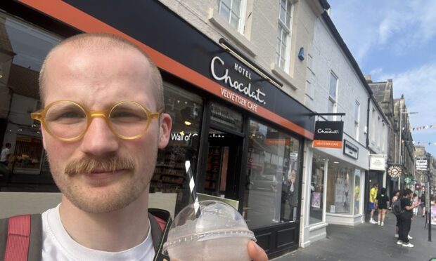 Jacob Smith posing in front of the Hotel Chocolat store in St Andrews