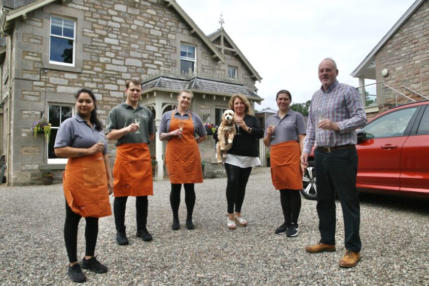 Group of people with champagne glasses outside Craigmhor B&B, Pitlochry