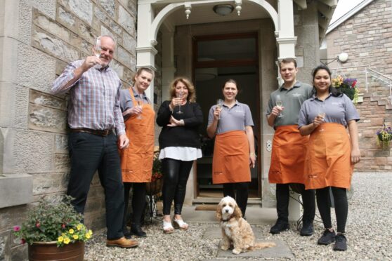 Group of people holding champagne outside Craigmhor Lodge, Pitlochry