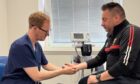 Dr Jonathan Begley, left, working at the new RCDS clinic.