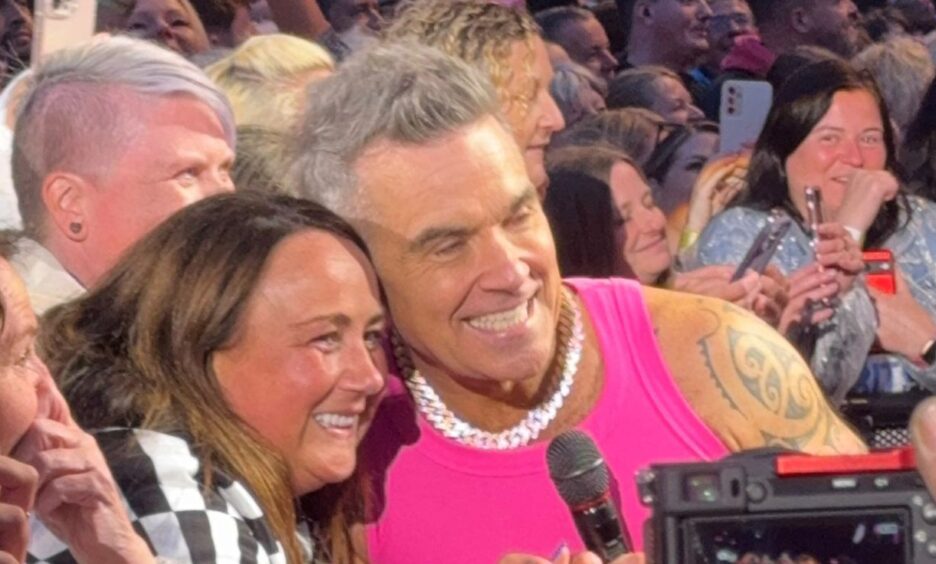 Debbie Allan with Robbie Williams at Murrayfield.