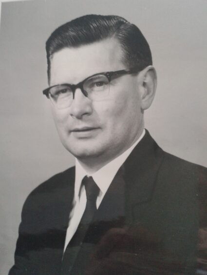 Bank manager Ron Duncan wearing glasses and a suit