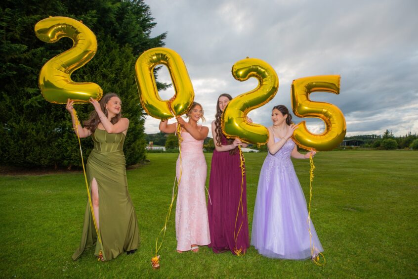 Neela Stather, Flora McNab, Katie Hemstad and Imogen Ferguson holding balloons spelling out 2025.