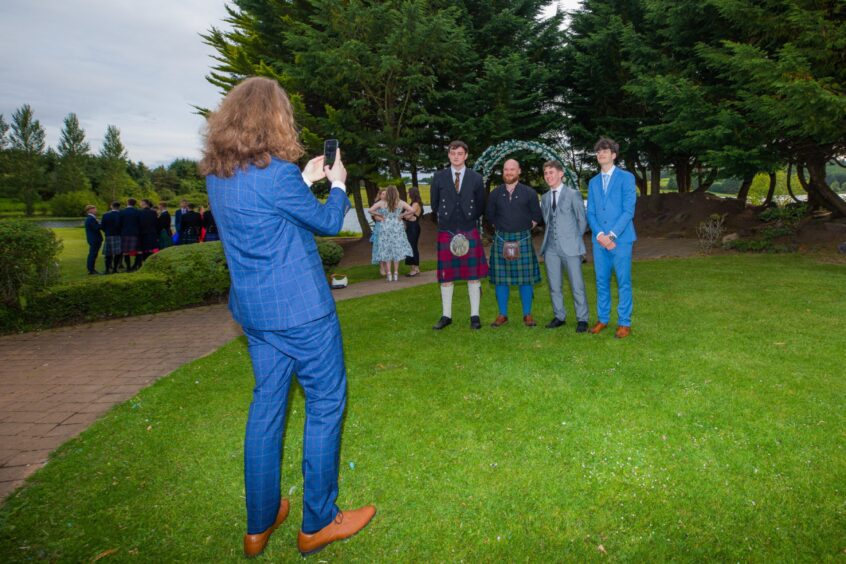 Revellers smile as someone takes a photograph