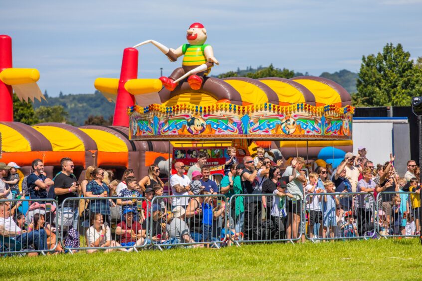 Crowds watch the monster trucks.