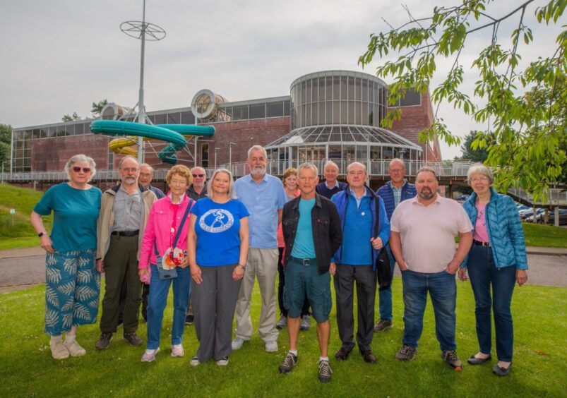 Small group of people standing on grass in front of Perth Leisure Pool