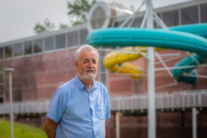 Dave Munro, standing in front of Perth leisure Pool flumes