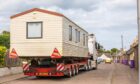 Tony Lindsay's static caravan is transported from Ireland Street on Monday. Image: Steve MacDougall/DC Thomson