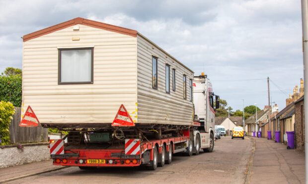 Tony Lindsay's static caravan is transported from Ireland Street on Monday. Image: Steve MacDougall/DC Thomson