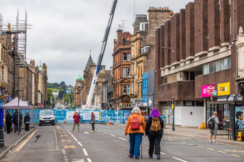 Close off junction of Scott Street/South Street, Perth, with crane behind and pedestrians looking on