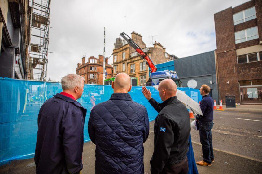 Mr Swinney observing the damage. 