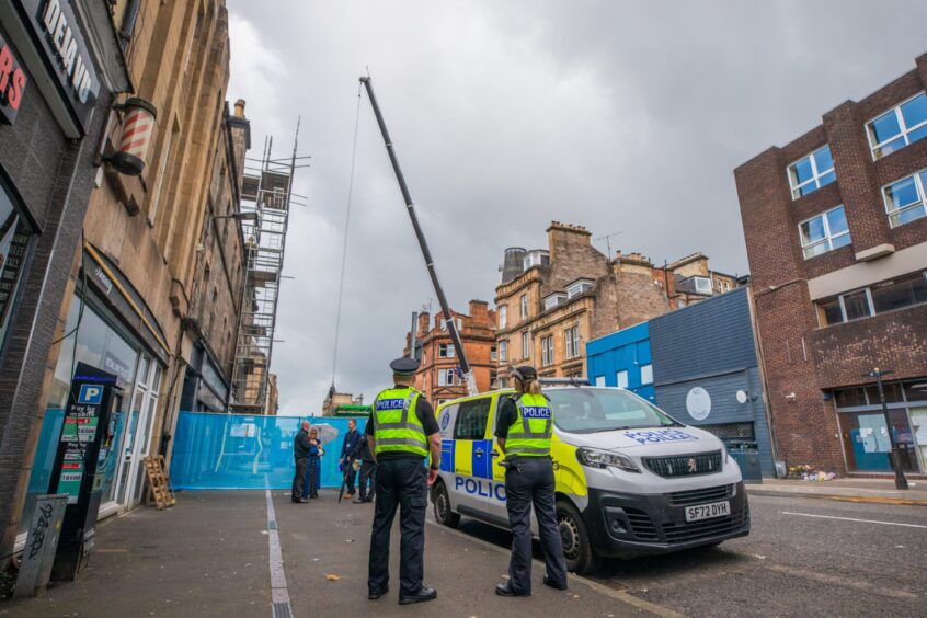 Police and a crane on South Street in the wake of the fire. 
