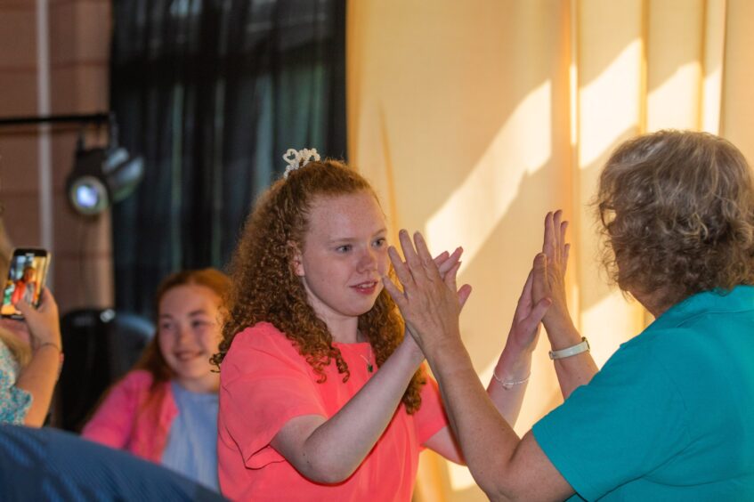 A woman and a girl dance together at the Fairview School leavers' party 2025.
