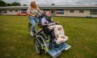 Poppy is delighted as she rides round Kingspark School with mum Sharon. Image: Steve MacDougall/DC Thomson.