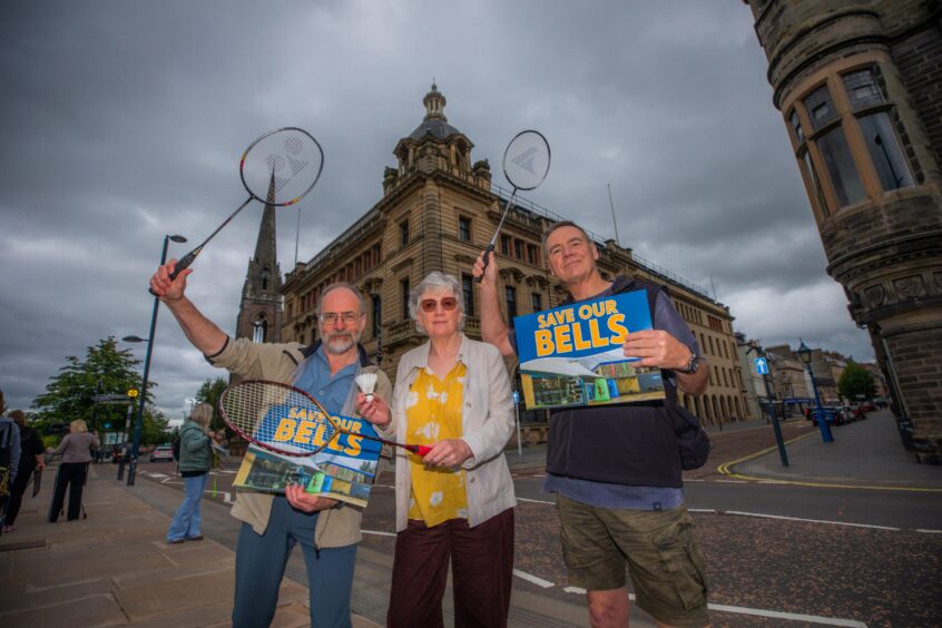 Three people with 'Save Bells' placards and badminton raquets outside Perth and Kinross Council HQ.