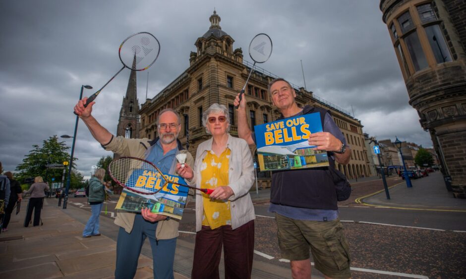 Three people with 'Save Bells' placards and badminton raquets outside Perth and Kinross Council HQ.