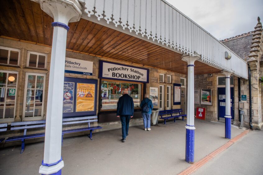 People standing outside Pitlochry station bookshop at the station