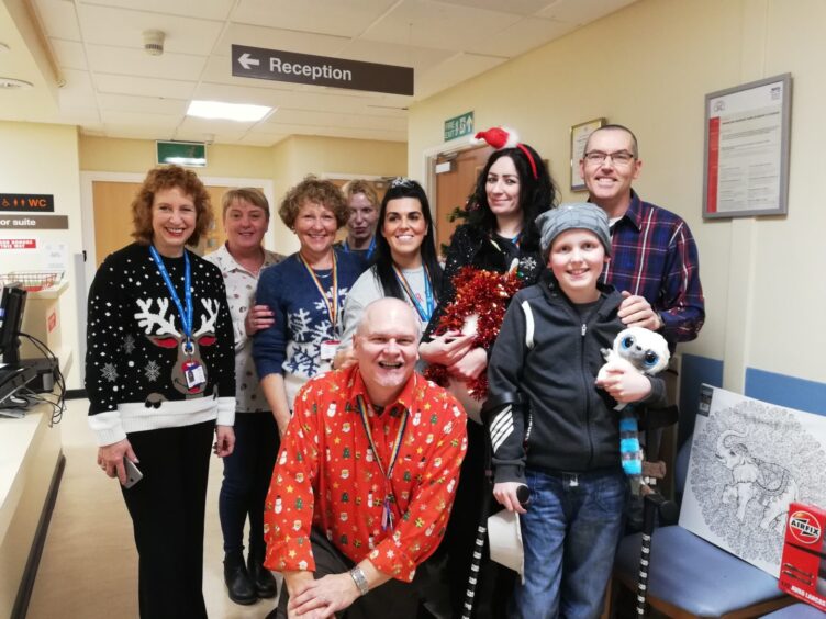 Aaron with members of the Scottish National Blood Transfusion Service. Blood donations saved his life