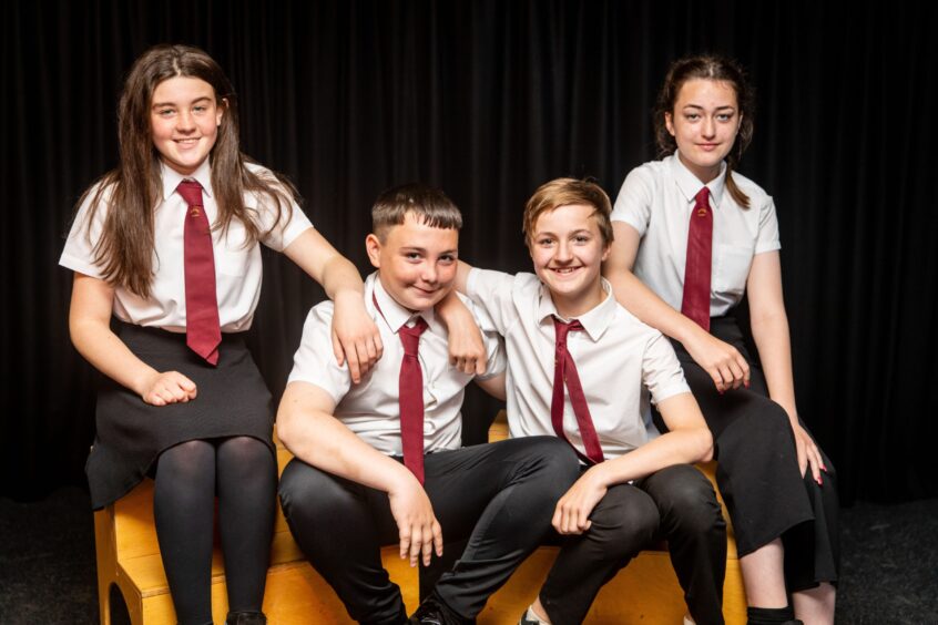 Katie Houston, Billy Marr, Byron Smith and Erin Dunn seated and posing for a picture