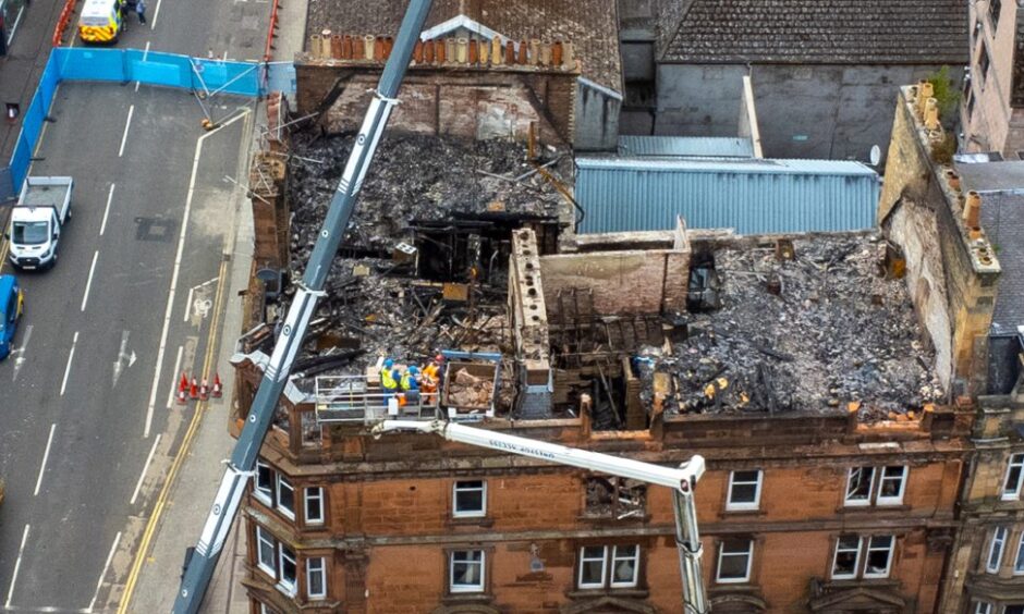 An elevated shot shows the gutted building and aftermath of the fatal fire on Scott Street, Perth.