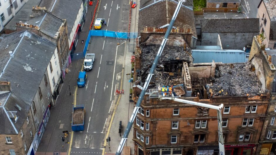 Demolition is under way at the fire-hit Scott Street building in Perth 
