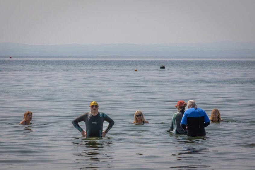 Swimmers at Lower Largo, Fife, where there are concerns about sea water quality and dirty beaches.