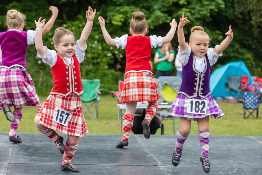 Small girls compete in the Highland dancing.